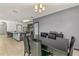Open concept dining room with kitchen view and six black chairs at 3450 Landing Vw, Tavares, FL 32778