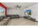 Living room with gray sectional sofa and large flat screen TV at 3450 Landing Vw, Tavares, FL 32778