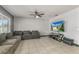 Living room with gray sectional sofa and large flat screen TV at 3450 Landing Vw, Tavares, FL 32778