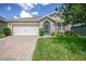 One-story home with attached garage and landscaped yard at 3450 Landing Vw, Tavares, FL 32778