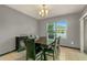 Dining room features a dark wood table and six black chairs at 3450 Landing Vw, Tavares, FL 32778
