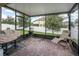 Screened porch with brick pavers and lounge chair at 3450 Landing Vw, Tavares, FL 32778