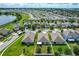 Aerial view of houses and neighborhood near a lake at 3450 Landing Vw, Tavares, FL 32778