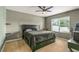 Bedroom with a queen bed, ceiling fan, and window at 3450 Landing Vw, Tavares, FL 32778