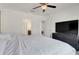 Main bedroom with large bed, en-suite bathroom access, and TV at 9708 Kinmore Dr, Groveland, FL 34736