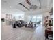Open living room featuring high ceilings, exposed beams, and a view to the kitchen and backyard at 3457 Lake Diane Rd, Tavares, FL 32778