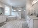 Spa-like Primary bathroom with a soaking tub, walk-in shower, and dual vanities at 3457 Lake Diane Rd, Tavares, FL 32778