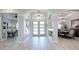 Bright and airy entryway with wood-look tile floors, showcasing views to the living room and dining area at 3457 Lake Diane Rd, Tavares, FL 32778