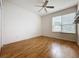 Well-lit bedroom with wood flooring and built in shelving at 2109 Grafton Ave, Clermont, FL 34711