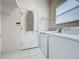 Laundry room with washer, dryer, and built-in shelving at 2109 Grafton Ave, Clermont, FL 34711