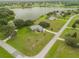 Aerial view of house and neighborhood with lake access at 23555 Milford Dr, Eustis, FL 32736