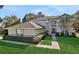 Two-story house with a gray exterior, brown roof, and landscaped yard at 24126 Plymouth Hollow Cir, Sorrento, FL 32776