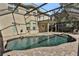 Freeform swimming pool with a screened enclosure and adjacent patio at 24126 Plymouth Hollow Cir, Sorrento, FL 32776