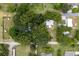 An overhead view of the property showing home and trees at 104 Fruitwood Ave, Eustis, FL 32726