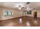 Spacious living room featuring hardwood floors and ceiling fans at 104 Fruitwood Ave, Eustis, FL 32726