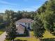 Aerial view of house with lush green surroundings and a basketball hoop at 24126 Plymouth Hollow Cir, Sorrento, FL 32776