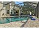 Inviting freeform pool with a screened enclosure and pavers at 24126 Plymouth Hollow Cir, Sorrento, FL 32776