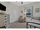 Relaxing bedroom with a daybed, armchair, and plenty of natural light at 24126 Plymouth Hollow Cir, Sorrento, FL 32776
