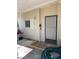 Tan house exterior with a grey door and white shutters at 34323 Island Dr, Leesburg, FL 34788
