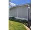 Home exterior with screened lanai and landscaped lawn at 34323 Island Dr, Leesburg, FL 34788