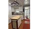 Bright kitchen featuring an island and wood flooring at 34323 Island Dr, Leesburg, FL 34788