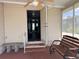Screened porch with a wooden bench and access to the house at 34323 Island Dr, Leesburg, FL 34788
