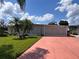 Single story home with carport and landscaped lawn at 34323 Island Dr, Leesburg, FL 34788