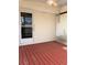 Red wooden deck with a screened enclosure at 34323 Island Dr, Leesburg, FL 34788