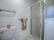 Bathroom with shower, grab bars, and linen closet at 1302 Oporto Dr, The Villages, FL 32162