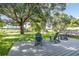 Enjoy the shade under this large tree, while relaxing on this spacious deck at 27637 Lisa Dr, Tavares, FL 32778