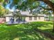 Spacious backyard deck with seating area, overlooking a large grassy yard at 27637 Lisa Dr, Tavares, FL 32778