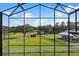 View from screened porch showcasing expansive pastures and farm buildings at 39400 French Rd, Lady Lake, FL 32159