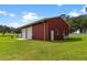 Red barn with double doors and a side window at 39400 French Rd, Lady Lake, FL 32159