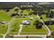 Aerial view of a home on a large lot with a barn and white fences at 39400 French Rd, Lady Lake, FL 32159