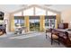 Main bedroom with high ceilings, large windows, and access to a balcony at 39400 French Rd, Lady Lake, FL 32159