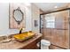 Bathroom with gold vessel sink, granite countertop, and glass shower at 39400 French Rd, Lady Lake, FL 32159
