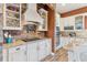 Modern kitchen with granite countertops, white cabinets, and a stone accent wall at 39400 French Rd, Lady Lake, FL 32159