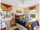Bedroom with a queen-size bed, fall-themed decor, and large windows at 39400 French Rd, Lady Lake, FL 32159