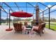 Relaxing enclosed patio with fireplace and seating area, offering scenic views at 39400 French Rd, Lady Lake, FL 32159