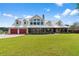 Farmhouse style home with metal roof and red doors, large windows at 39400 French Rd, Lady Lake, FL 32159