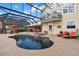 Inviting pool and spa with covered patio and lounge chairs, overlooking scenic landscape at 39400 French Rd, Lady Lake, FL 32159