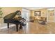 Elegant piano room with tiled floors, comfortable seating, and access to outdoor patio at 39400 French Rd, Lady Lake, FL 32159