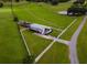 Aerial view showing a home, fenced pastures, and a pond at 39400 French Rd, Lady Lake, FL 32159
