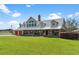 Spacious two-story house with metal roof and large windows at 39400 French Rd, Lady Lake, FL 32159