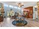 Bright dining room with hardwood floors and a stone fireplace at 39400 French Rd, Lady Lake, FL 32159