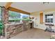 Outdoor kitchen with stone countertops, grill, and sink at 39400 French Rd, Lady Lake, FL 32159