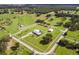 Aerial view of a large property with a house, barns, and fenced pastures at 39400 French Rd, Lady Lake, FL 32159