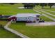 Aerial view of a mobile home on a large lot with a fenced area at 39400 French Rd, Lady Lake, FL 32159