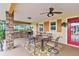 Outdoor patio with dining area, built-in grill, and red door at 39400 French Rd, Lady Lake, FL 32159