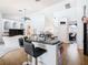 Kitchen island with seating and a view into the Gathering room and dining area at 139 Belfry Dr, Davenport, FL 33897